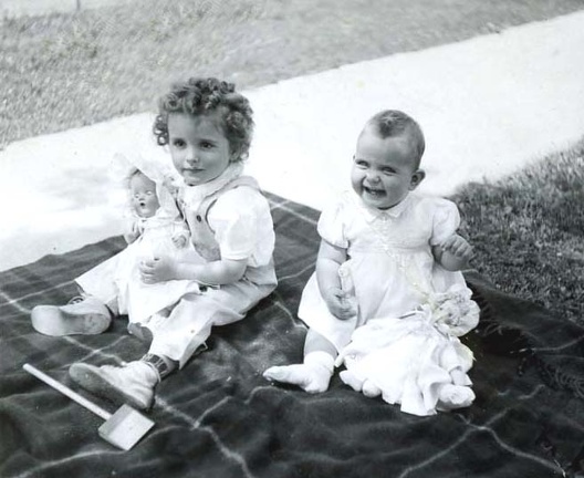 1943 Carole and Lynn with dolls outside