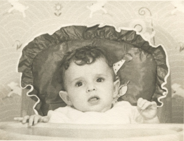 Carole Lee 1940 in her high chair with bo peep wall paper behind.jpeg