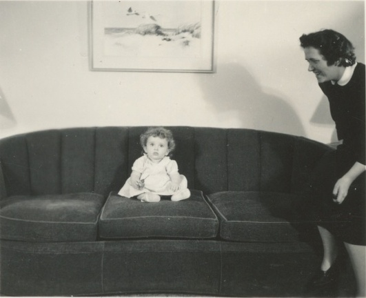 Carole Lee sitting on couch with Cora standing near 1941