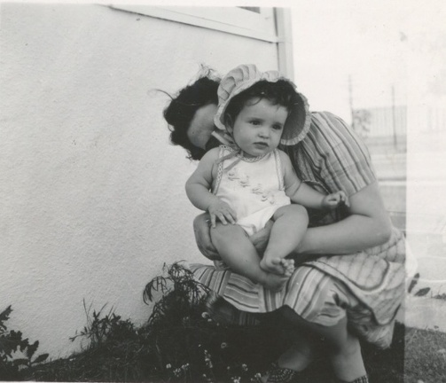 Cora snuggling the back of Carole Lee 1941 outside their house