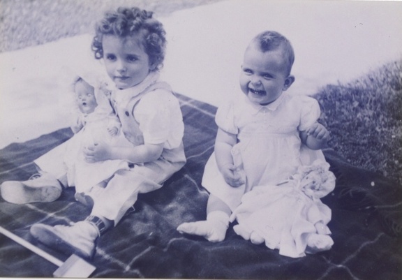 Carole and Lynn with dolls on blanket 1943