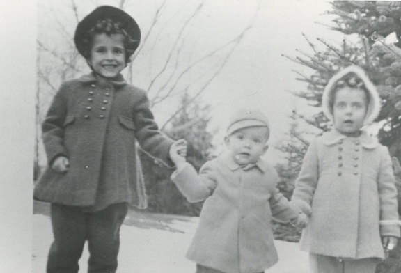 Carole, Jim and Lynn 1945 in winter coats holding hands