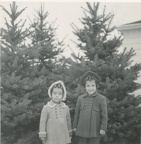 Lynn &amp; Carole in coats by pine trees 1945  2
