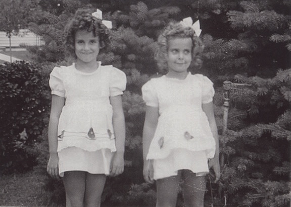 Carole and Lynn Stanard next to pine trees 1948