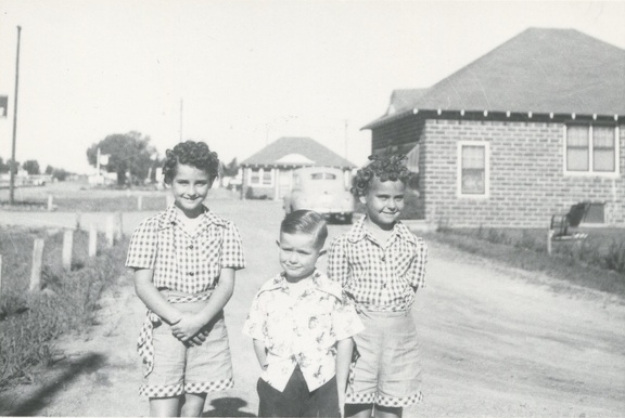Carole, Jim and Lynn outside on a gravel driveway about 1949
