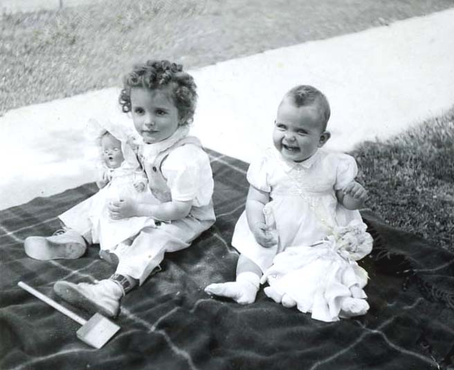 1943 Carole and Lynn with dolls outside.jpg